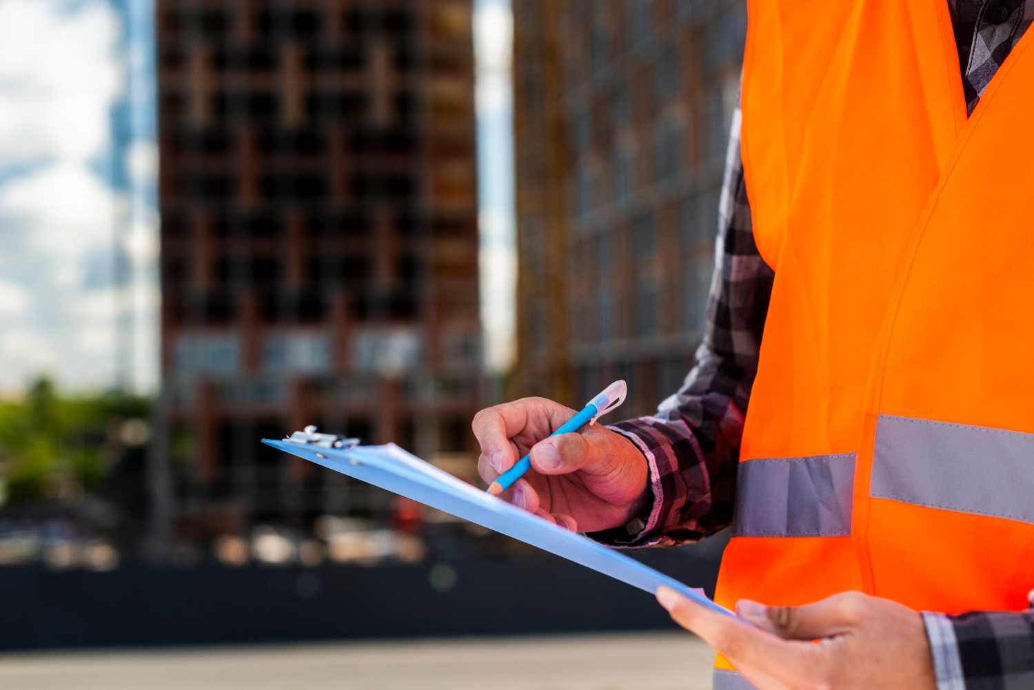 construction worker writing on notepad construction site safety mobile medical corporation